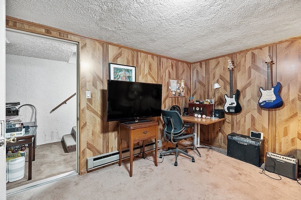 55 Littleton Road, Unit 2F Ayer, MA 01432 - Photo 22 of 29 a living room with furniture and a flat screen tv