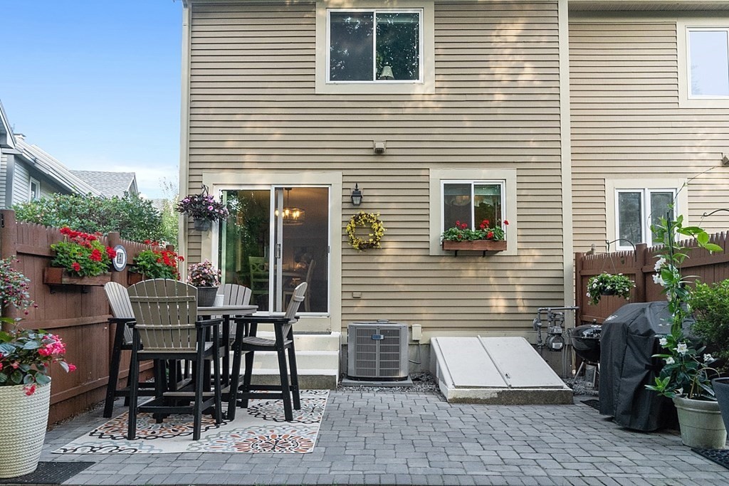 55 Littleton Road, Unit 2F Ayer, MA 01432 - Photo 23 of 29 a view of a patio with a table and chairs and potted plants