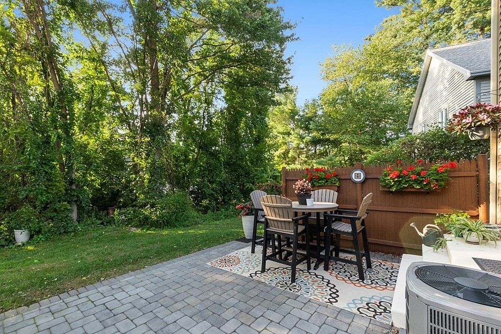 55 Littleton Road, Unit 2F Ayer, MA 01432 - Photo 25 of 29 a view of a chairs and table in backyard of the house