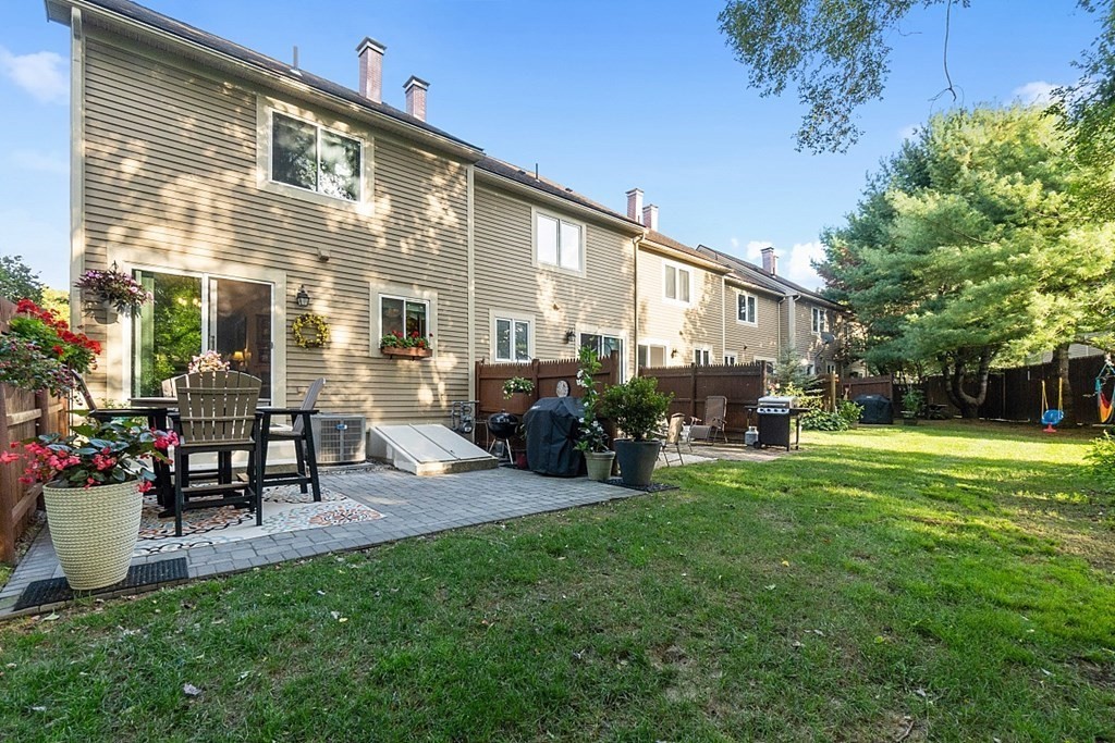 55 Littleton Road, Unit 2F Ayer, MA 01432 - Photo 27 of 29 a view of a house with backyard sitting area and garden