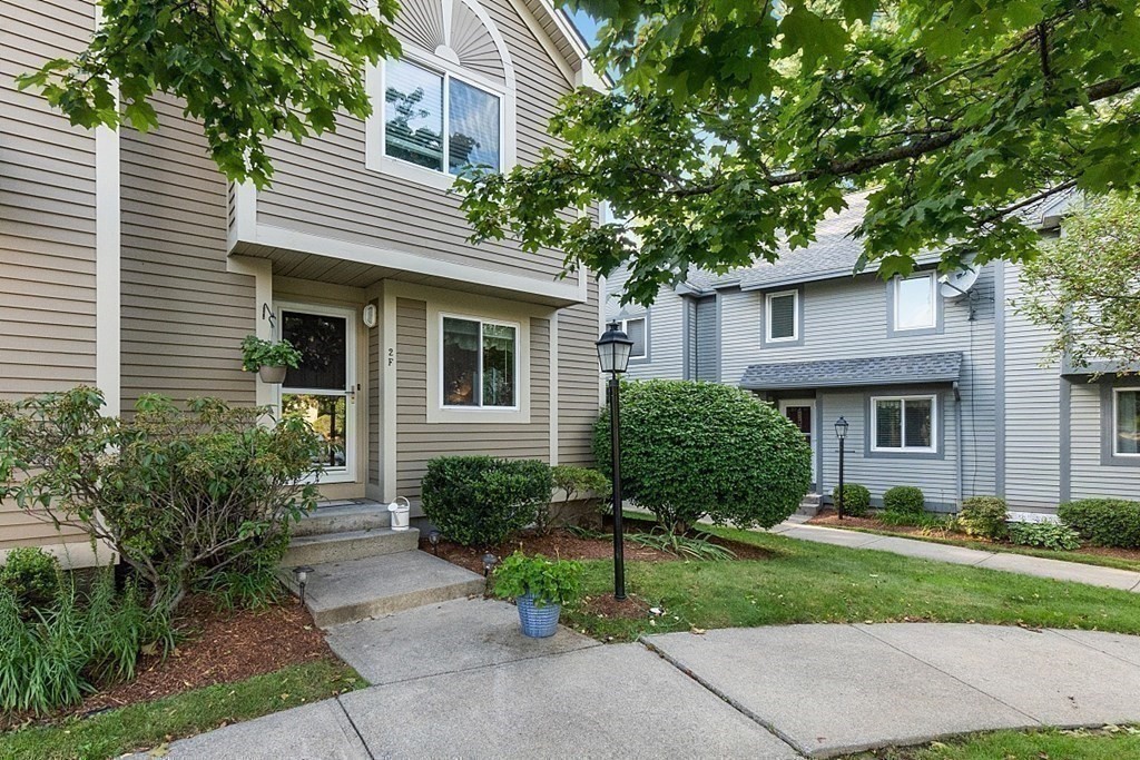 55 Littleton Road, Unit 2F Ayer, MA 01432 - Photo 28 of 29 a view of a house with a yard and plants