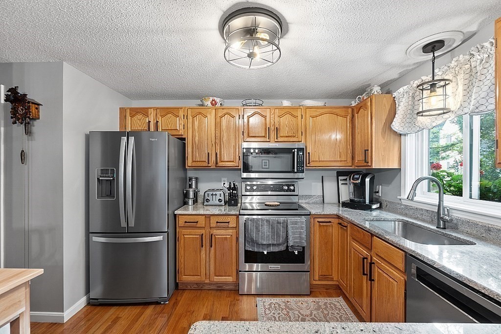 55 Littleton Road, Unit 2F Ayer, MA 01432 - Photo 8 of 29 a kitchen with stainless steel appliances granite countertop a refrigerator sink and stove
