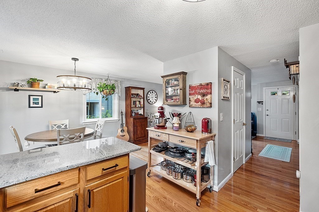 55 Littleton Road, Unit 2F Ayer, MA 01432 - Photo 10 of 29 a kitchen with stainless steel appliances granite countertop a lot of counter top space and wooden floor