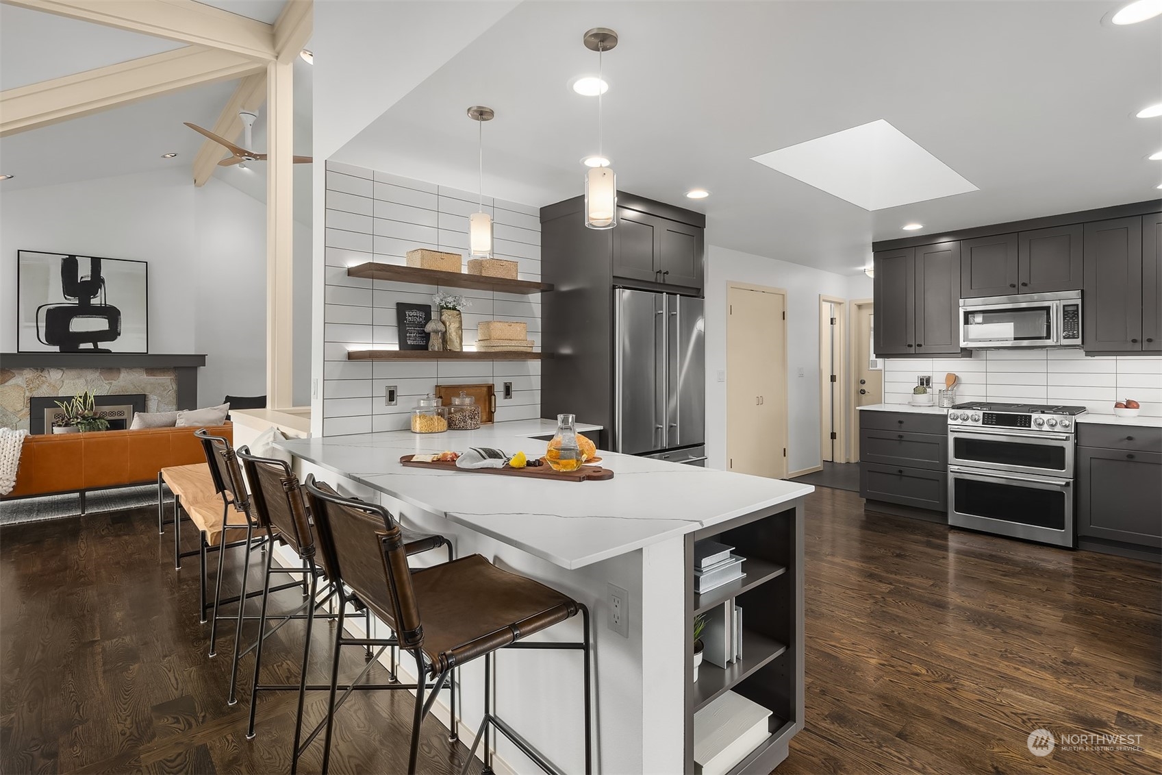 8457 Midland Road Medina, WA 98039 - Photo 16 of 40 a kitchen with stainless steel appliances a stove a sink a dining table and chairs