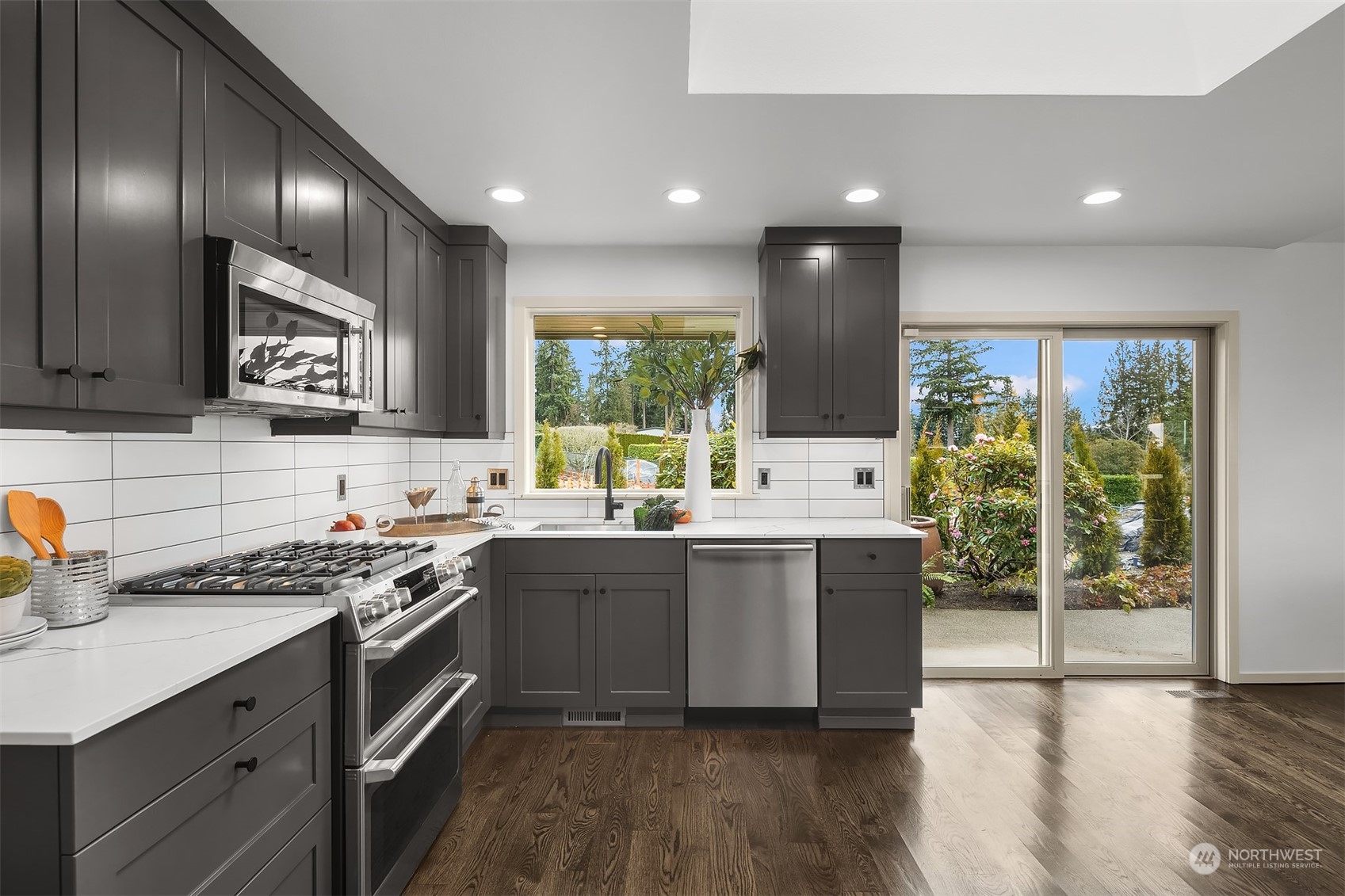 8457 Midland Road Medina, WA 98039 - Photo 22 of 40 a kitchen with stainless steel appliances granite countertop wooden cabinets stove top oven and sink