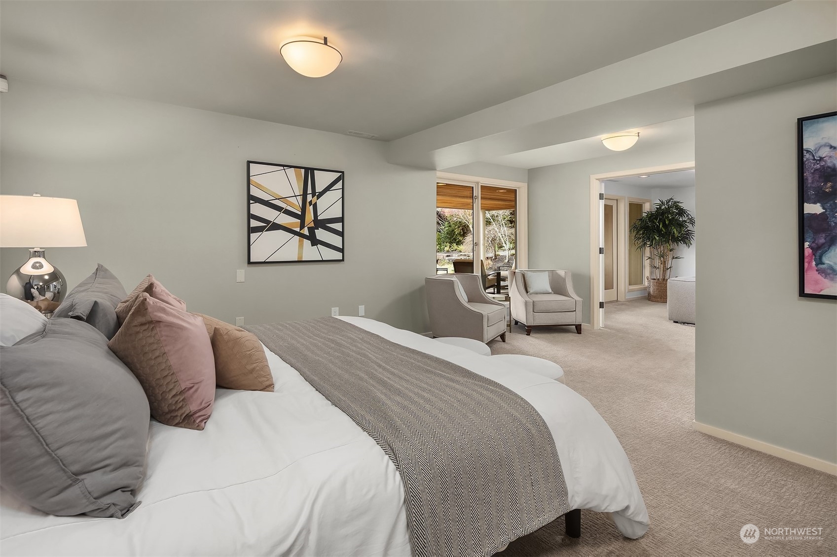 8457 Midland Road Medina, WA 98039 - Photo 31 of 40 a bedroom with a large bed and a chandelier