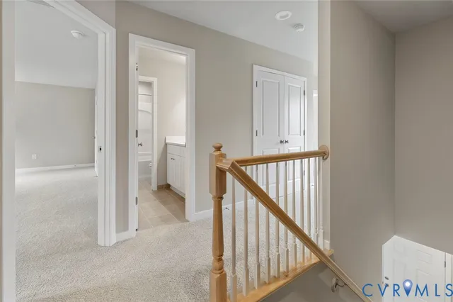 a view of a hallway with wooden floor and entryway