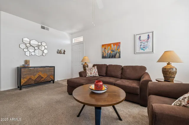 a living room with furniture and a table
