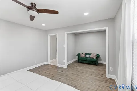 a living room with a couch and a ceiling fan