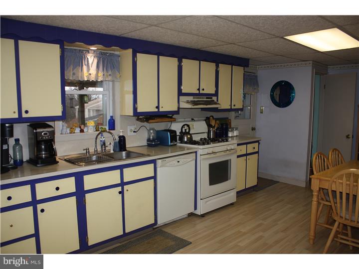 533 New Street Spring City, PA 19475 - Photo 7 of 23 a kitchen with stainless steel appliances a stove a sink a cabinets and a window