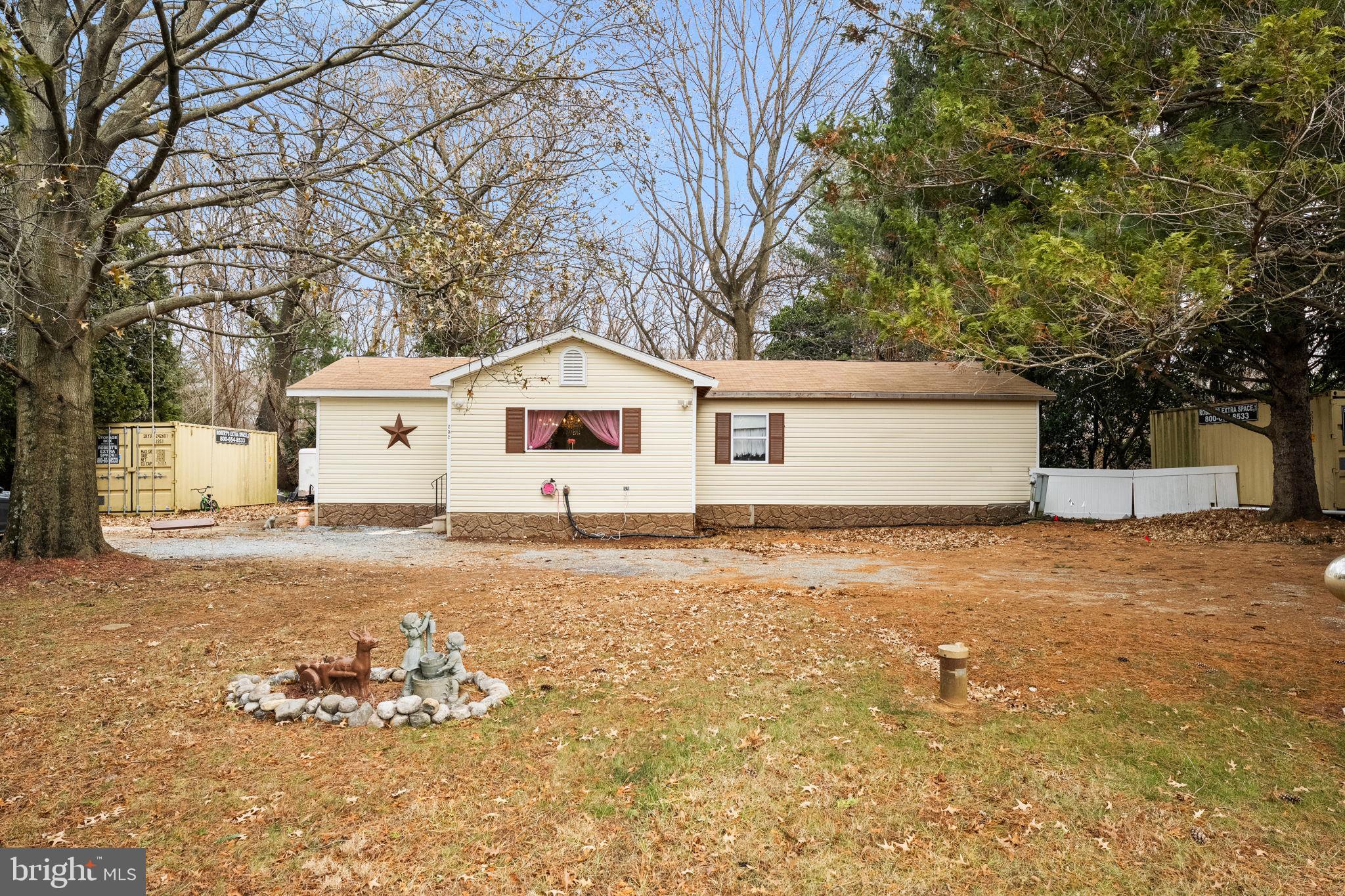 a view of a white house with a yard