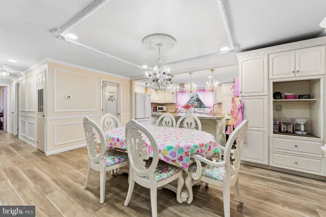 a view of a dining room with furniture and chandelier