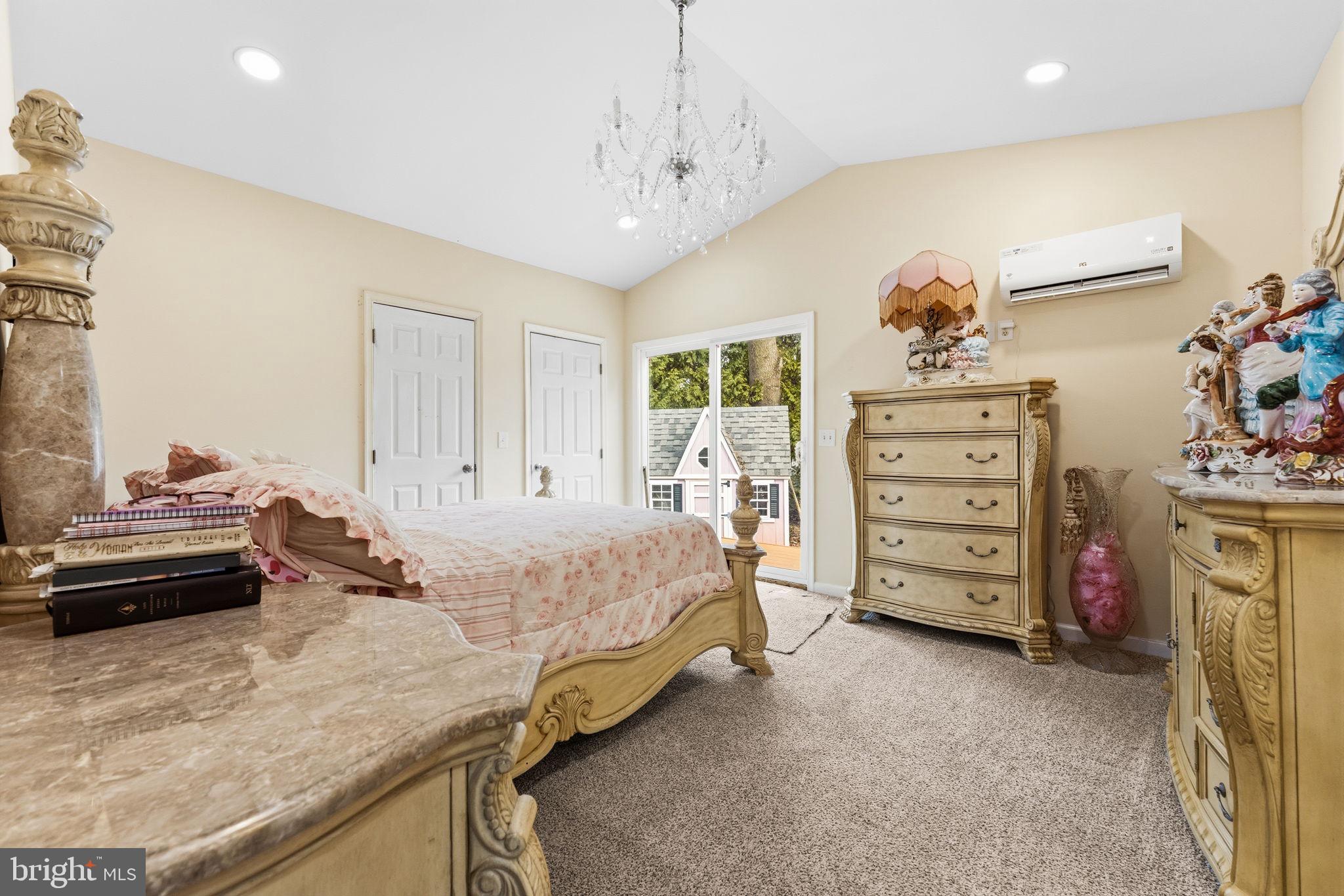 252 Red Pump Road Rising Sun, MD 21911 - Photo 22 of 41 a bedroom with a bed and a chandelier