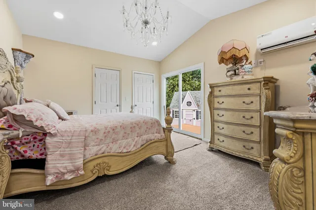 a spacious bedroom with a bed and a chandelier