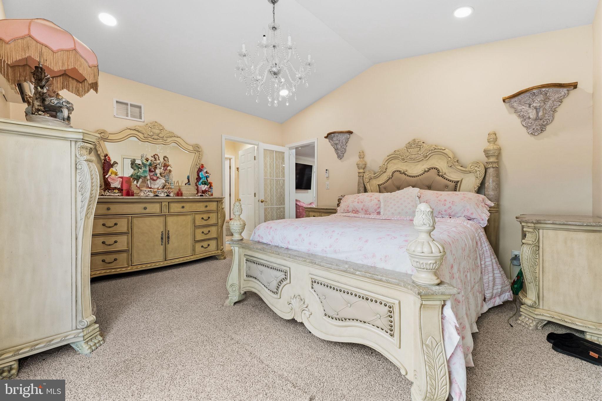 252 Red Pump Road Rising Sun, MD 21911 - Photo 24 of 41 a spacious bedroom with a bed and a chandelier