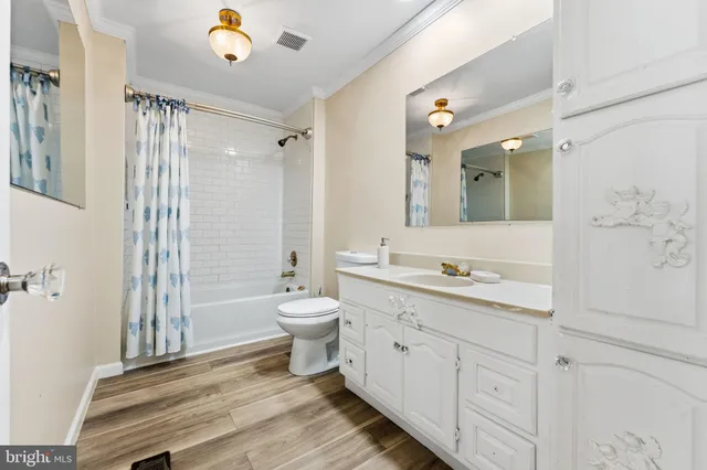 a bathroom with a granite countertop sink a toilet and a shower