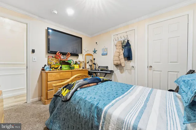 a bedroom that has a bed and a chandelier