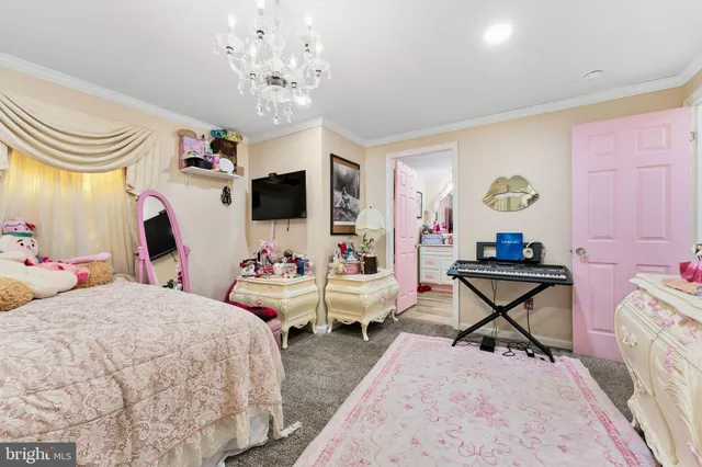 a bedroom with furniture and a chandelier