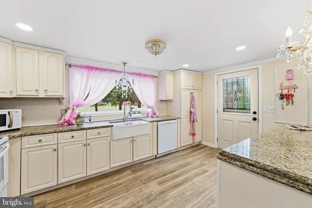 a kitchen with a sink stove and white cabinets
