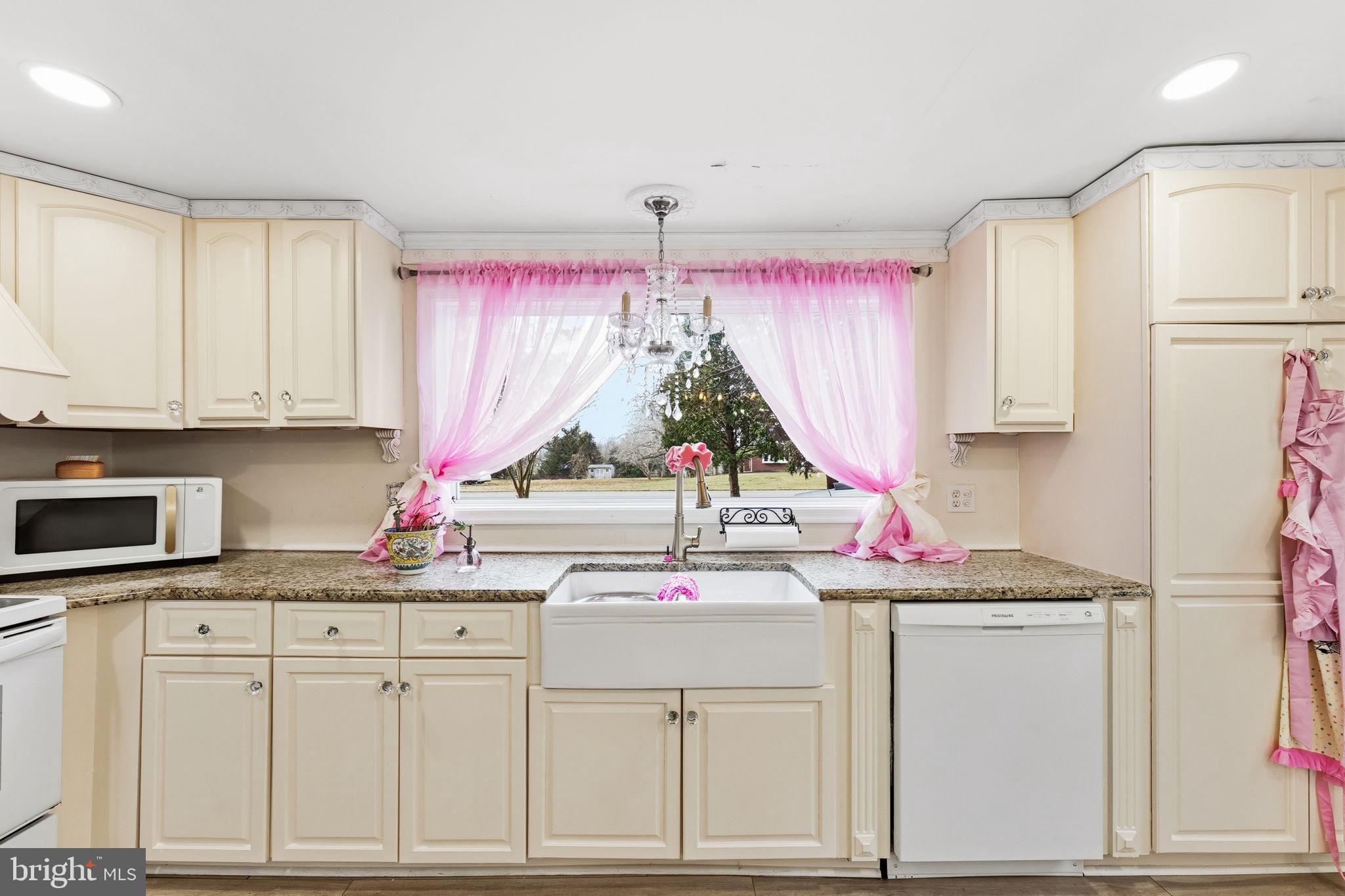 252 Red Pump Road Rising Sun, MD 21911 - Photo 8 of 41 a kitchen with a sink stove and white cabinets