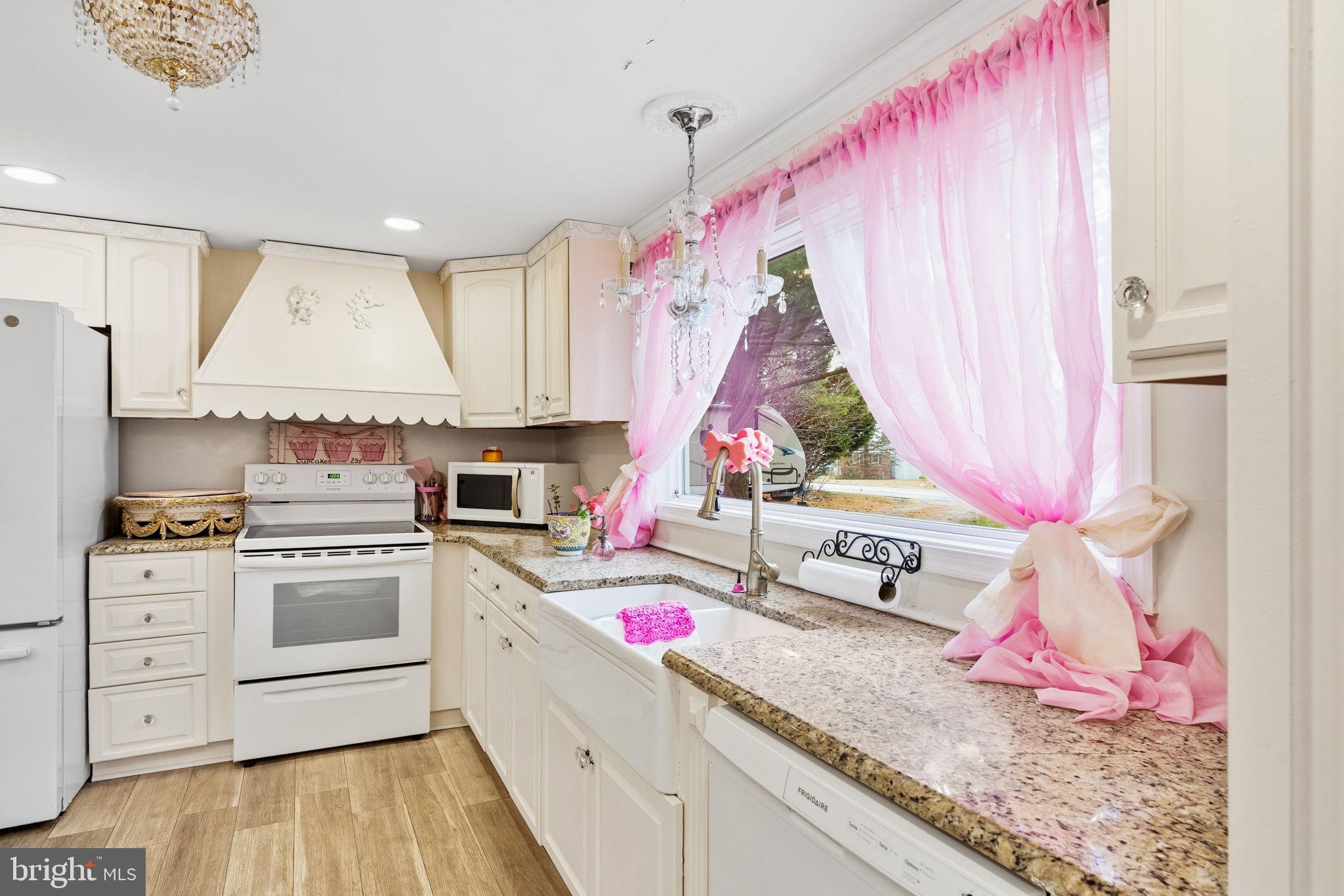 252 Red Pump Road Rising Sun, MD 21911 - Photo 9 of 41 a kitchen with white cabinets and sink