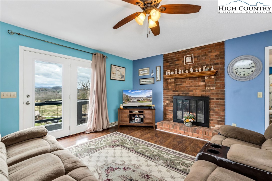 237 Valleyview Drive Jefferson, NC 28640 - Photo 12 of 42 a living room with furniture and a fireplace