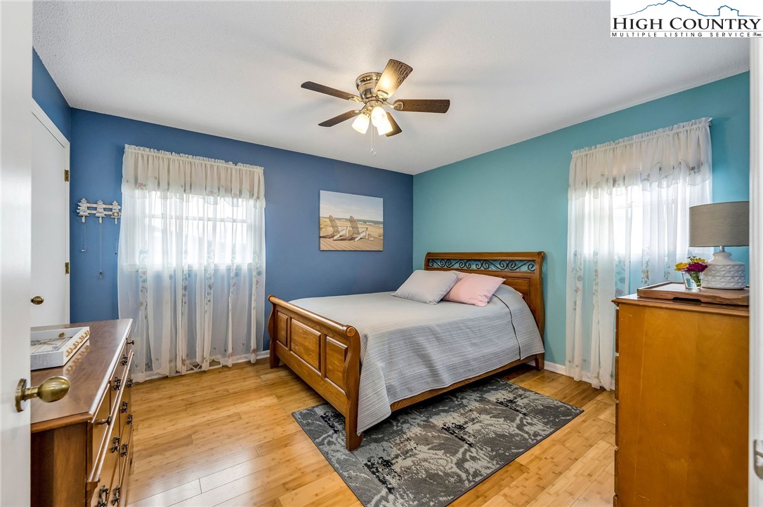 237 Valleyview Drive Jefferson, NC 28640 - Photo 21 of 42 a bedroom with a bed and a chandelier