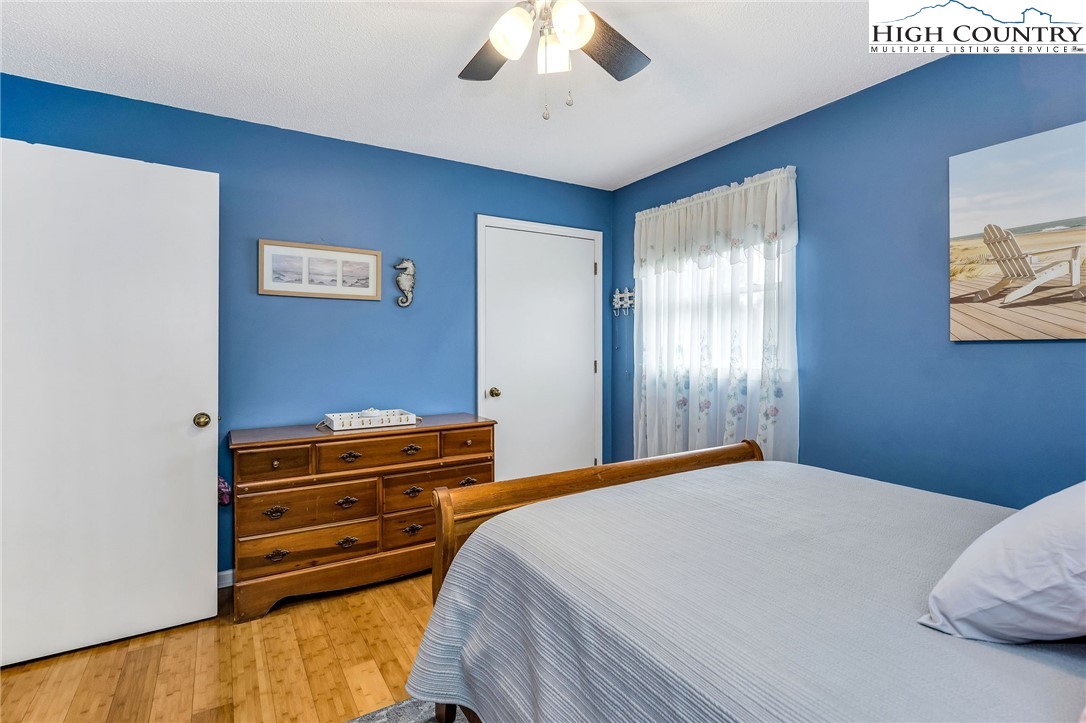237 Valleyview Drive Jefferson, NC 28640 - Photo 22 of 42 a bedroom with a bed and a chandelier