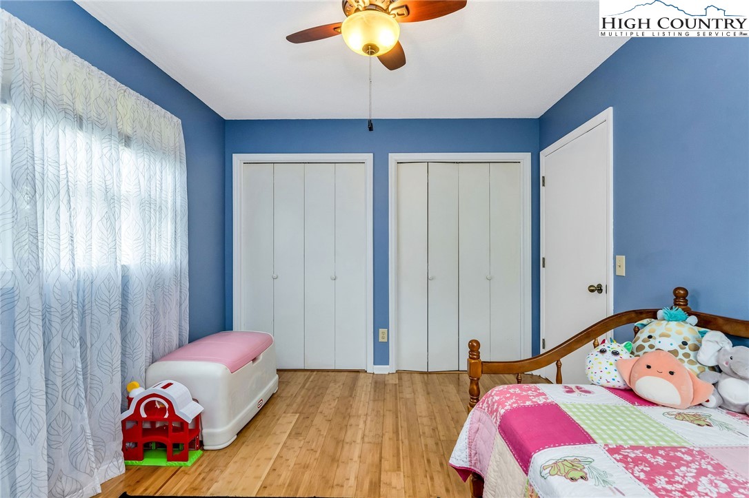 237 Valleyview Drive Jefferson, NC 28640 - Photo 28 of 42 a bedroom with a bed and a chandelier