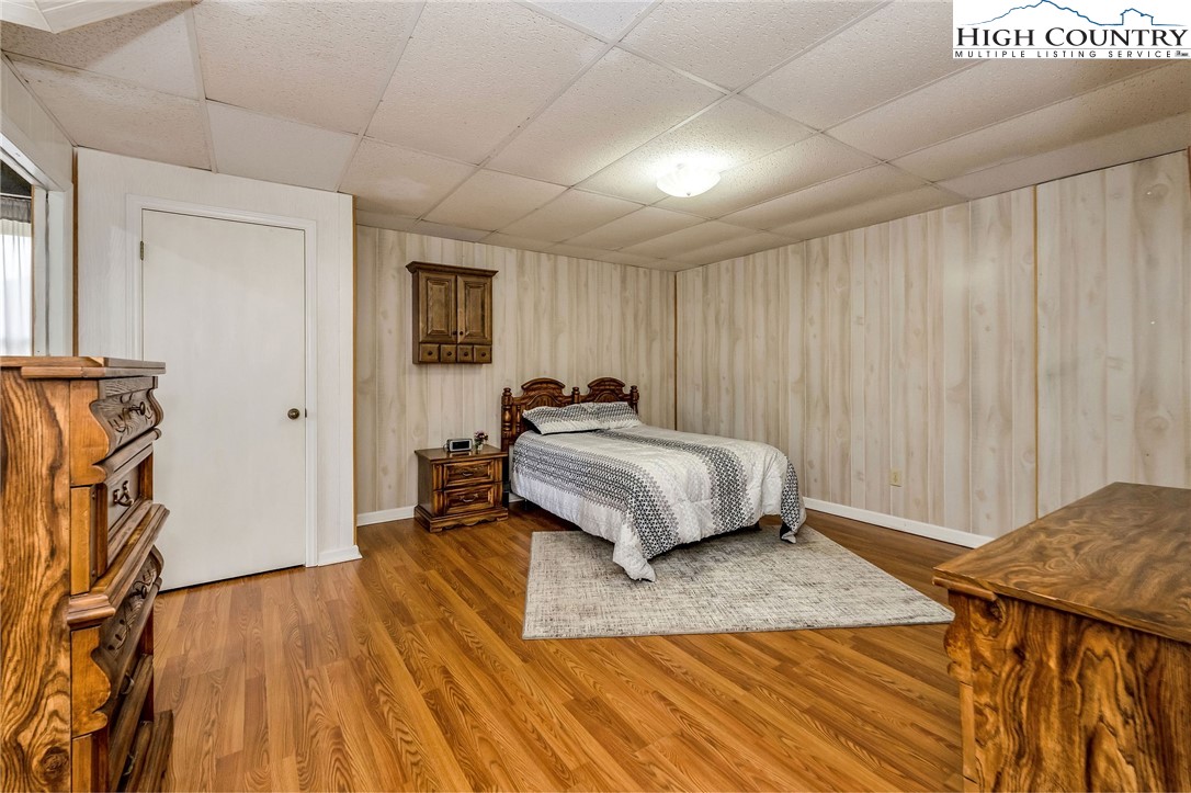 237 Valleyview Drive Jefferson, NC 28640 - Photo 40 of 42 a bedroom with a bed and a wooden floor