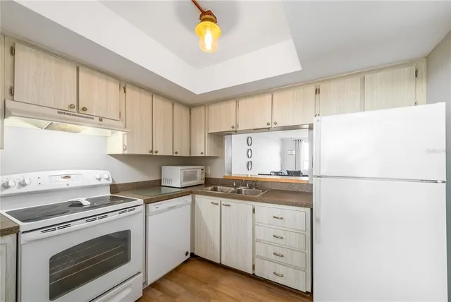 a kitchen with cabinets appliances and a counter space