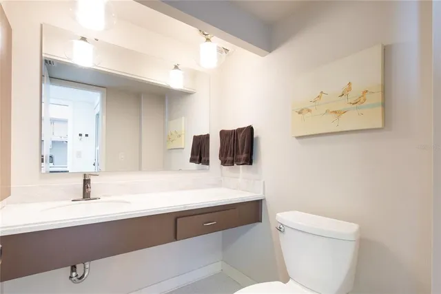 a bathroom with a sink a toilet and mirror