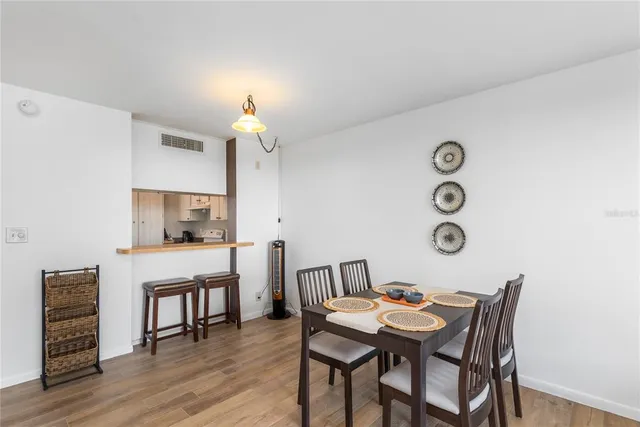 a view of a dining room with furniture and wooden floor