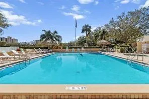 a swimming pool with outdoor seating and yard