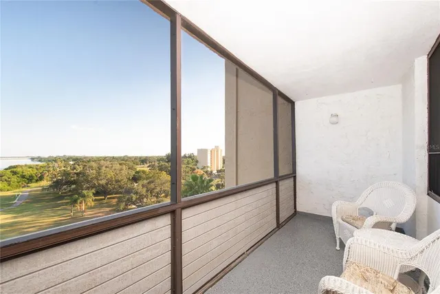 a view of a room with furniture and floor to ceiling window