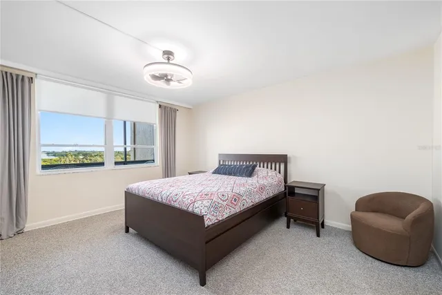 a spacious bedroom with a bed and a window