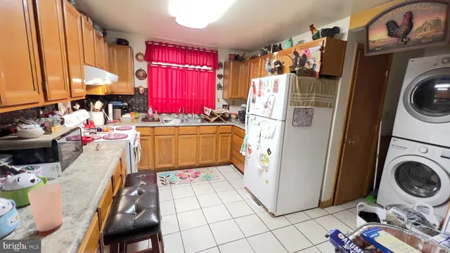 a view of a kitchen with a stove top oven a washer and dryer