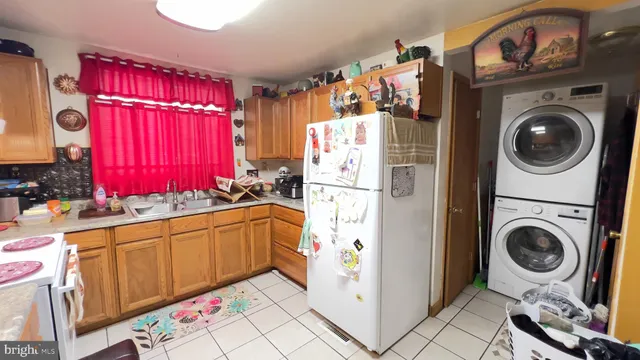 a kitchen with a refrigerator sink and cabinets