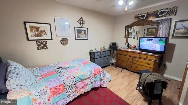 a bedroom with bed and wooden furniture