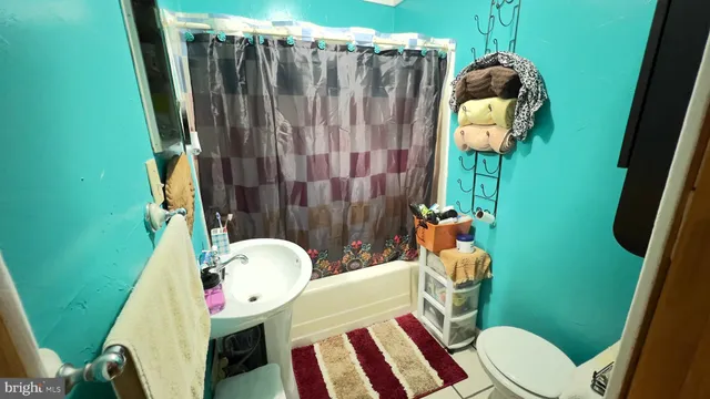 a bathroom with a toilet and a mirror