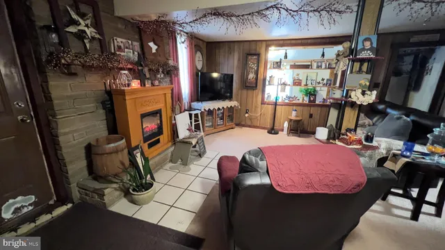 a room with furniture a fireplace and a flat screen tv