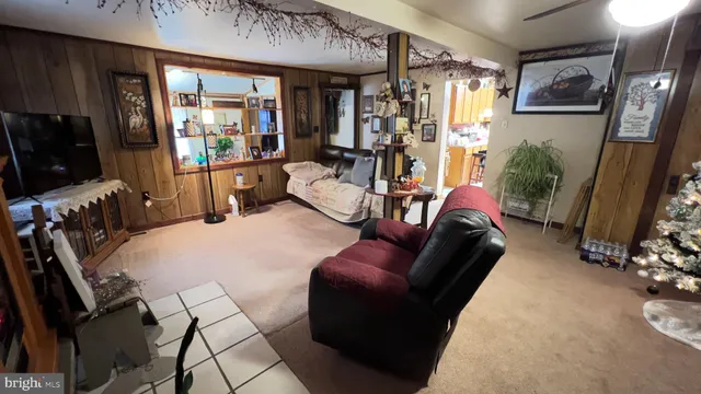 a living room with furniture a window and a flat screen tv