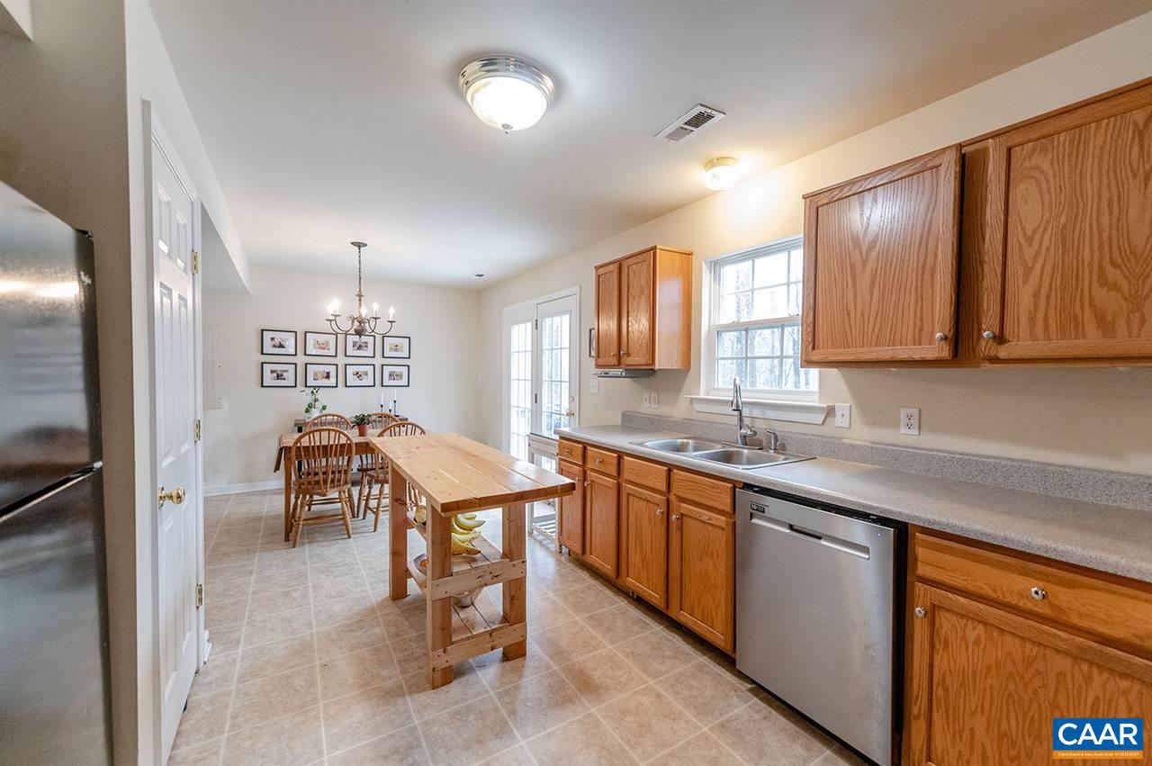 3683 Irish Road Esmont, VA 22937 - Photo 11 of 42 a kitchen with stainless steel appliances granite countertop a sink a stove counter space and cabinets