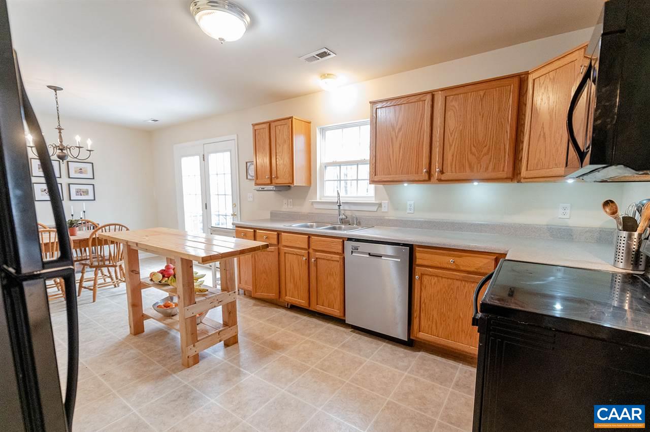 3683 Irish Road Esmont, VA 22937 - Photo 14 of 42 a kitchen with stainless steel appliances granite countertop a sink stove and cabinets