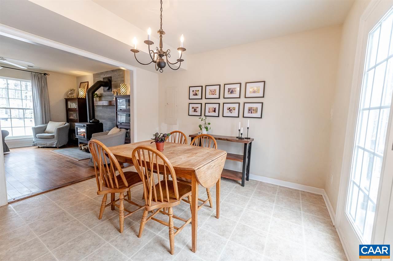 3683 Irish Road Esmont, VA 22937 - Photo 9 of 42 a view of a dining room with furniture wooden floor and chandelier