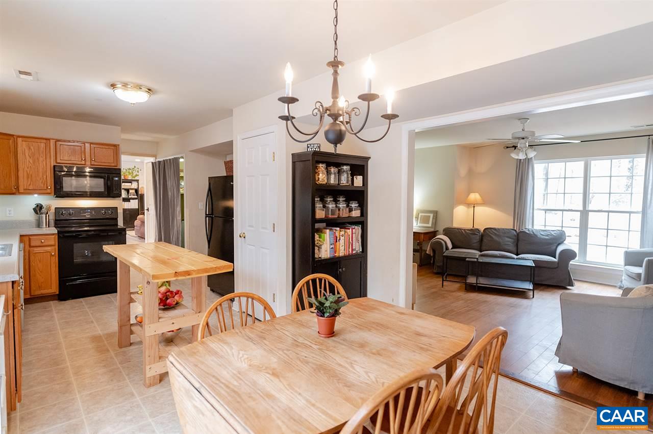 3683 Irish Road Esmont, VA 22937 - Photo 10 of 42 a living room with stainless steel appliances furniture a chandelier and a kitchen view
