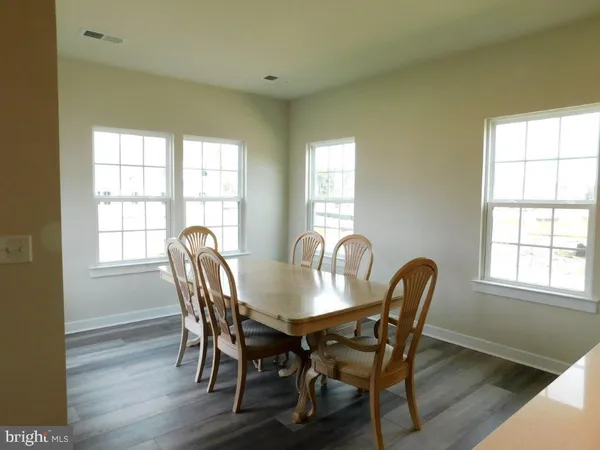 a view of a dining room with furniture and windows