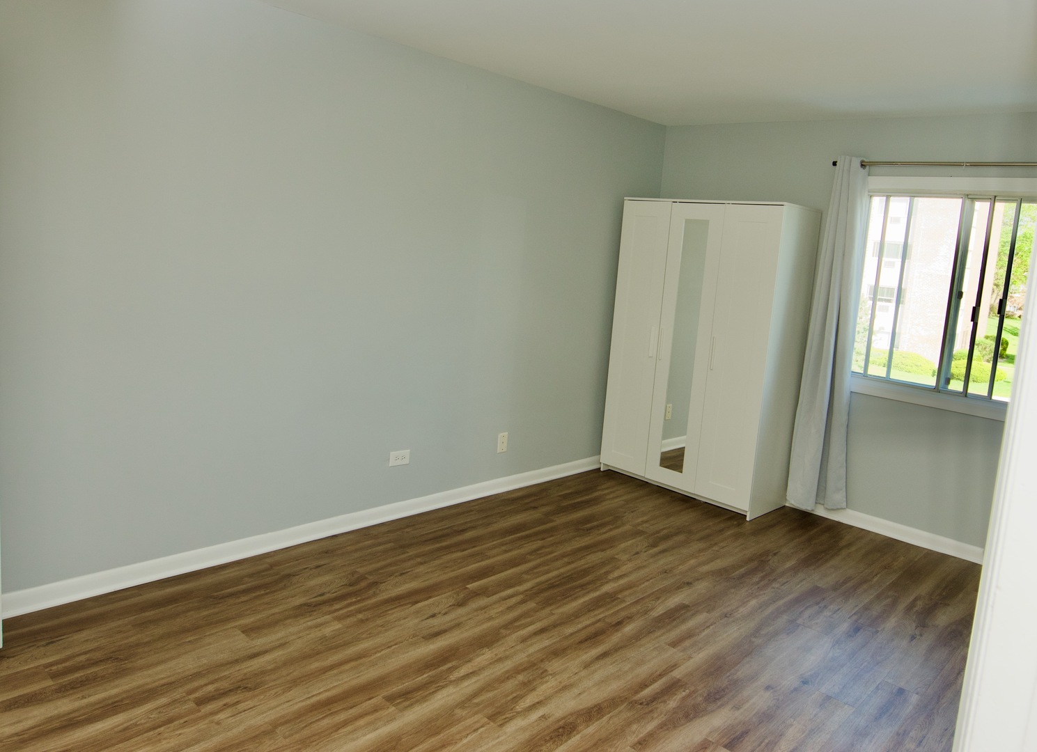 10347 Dearlove Road, Unit 301 Glenview, IL 60025 - Photo 11 of 13 an empty room with wooden floor and windows