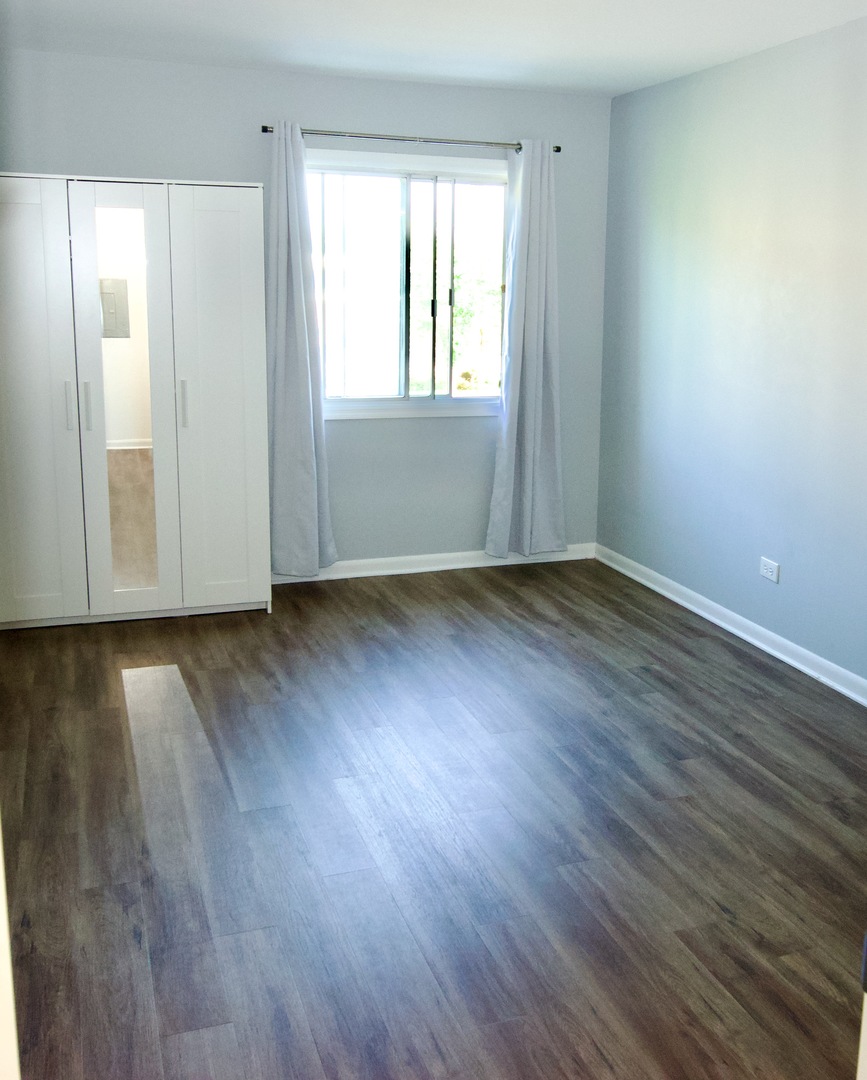 10347 Dearlove Road, Unit 301 Glenview, IL 60025 - Photo 12 of 13 an empty room with wooden floor and windows