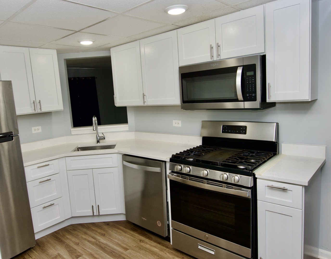 10347 Dearlove Road, Unit 301 Glenview, IL 60025 - Photo 3 of 13 a kitchen with stainless steel appliances a stove a microwave a sink and cabinets